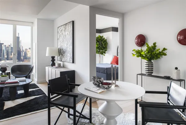 a view of a dining room with furniture and a potted plant