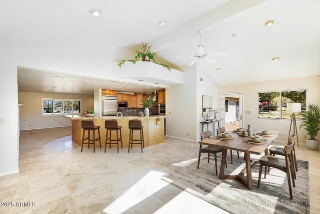 a kitchen with stainless steel appliances granite countertop a refrigerator a stove and a sink