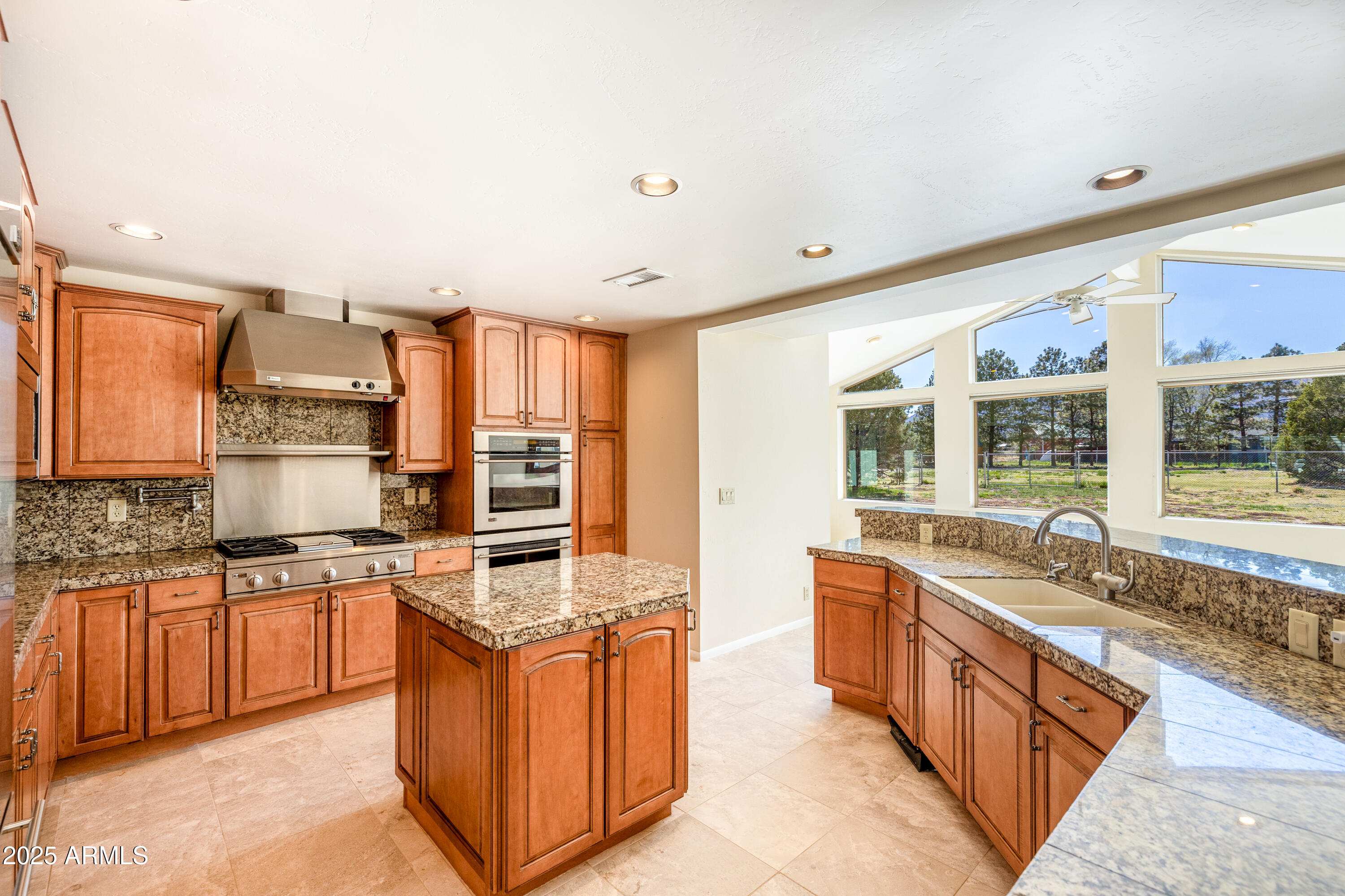 8230 Koch Field Road Flagstaff, AZ 86004 - Photo 15 of 69 a large kitchen with stainless steel appliances granite countertop a stove a sink and a microwave