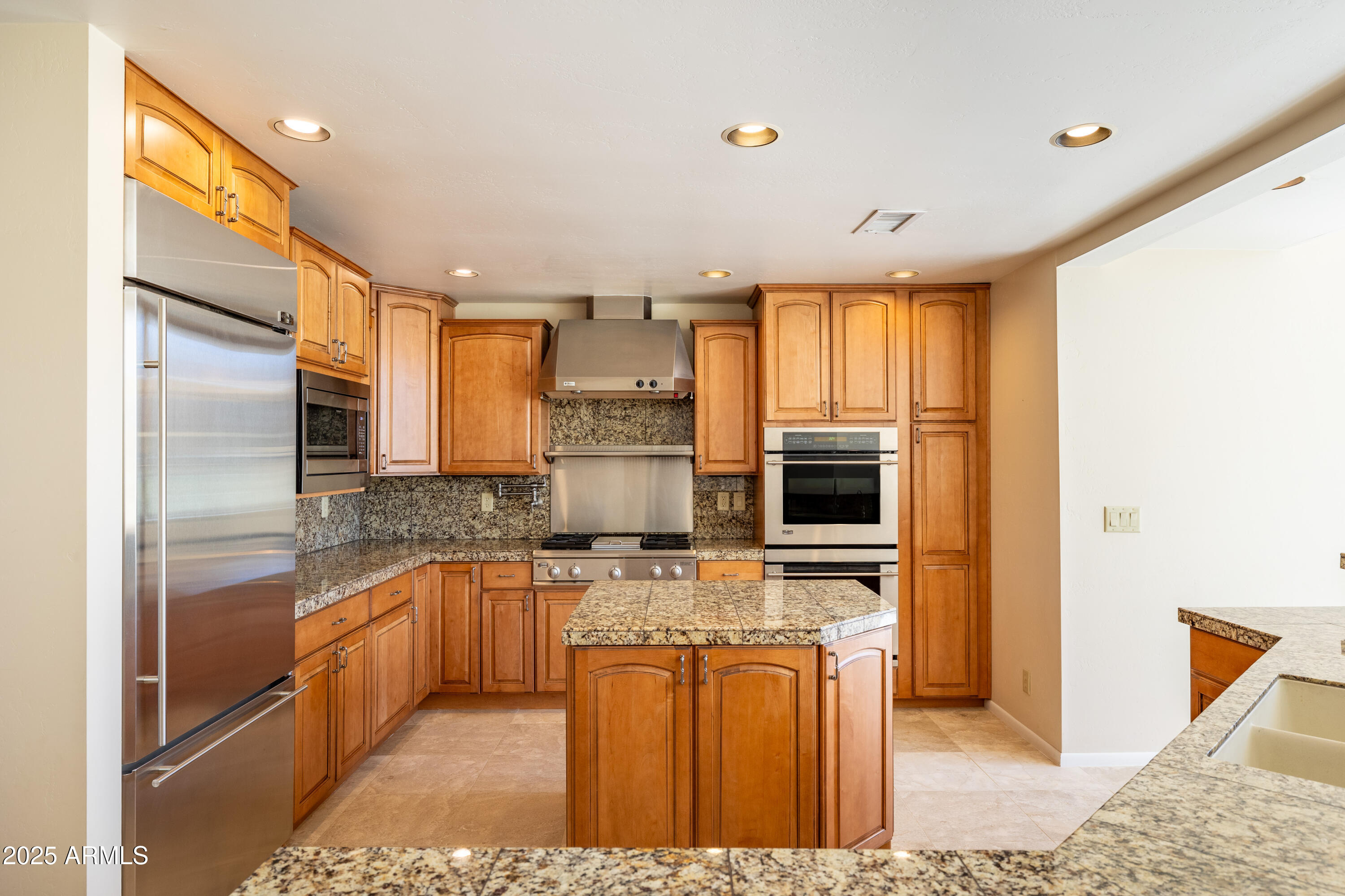 8230 Koch Field Road Flagstaff, AZ 86004 - Photo 19 of 69 a kitchen with stainless steel appliances granite countertop a refrigerator a stove and a sink