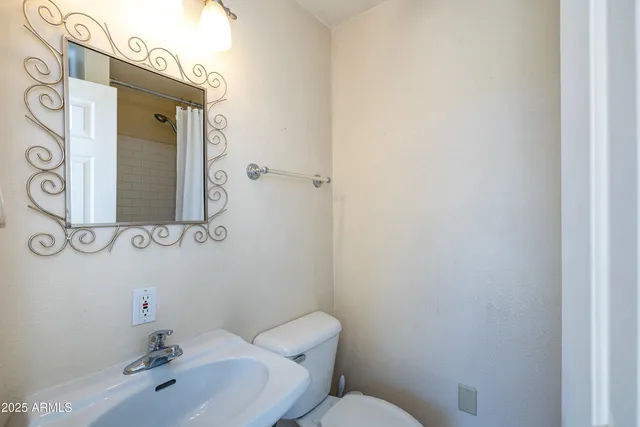 a bathroom with a granite countertop double vanity sink and mirror