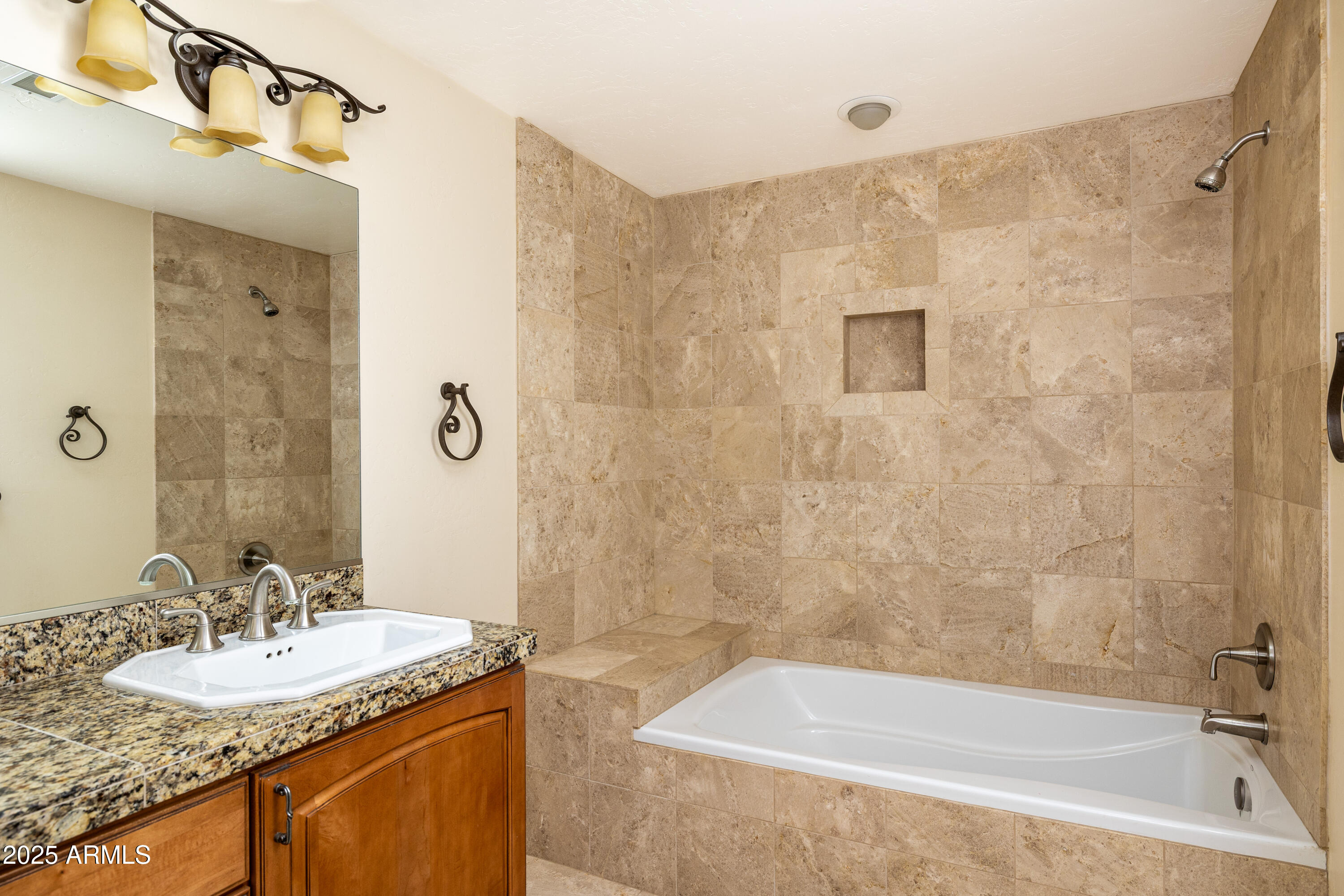 8230 Koch Field Road Flagstaff, AZ 86004 - Photo 37 of 69 a bathroom with a granite countertop sink a mirror a bathtub and shower