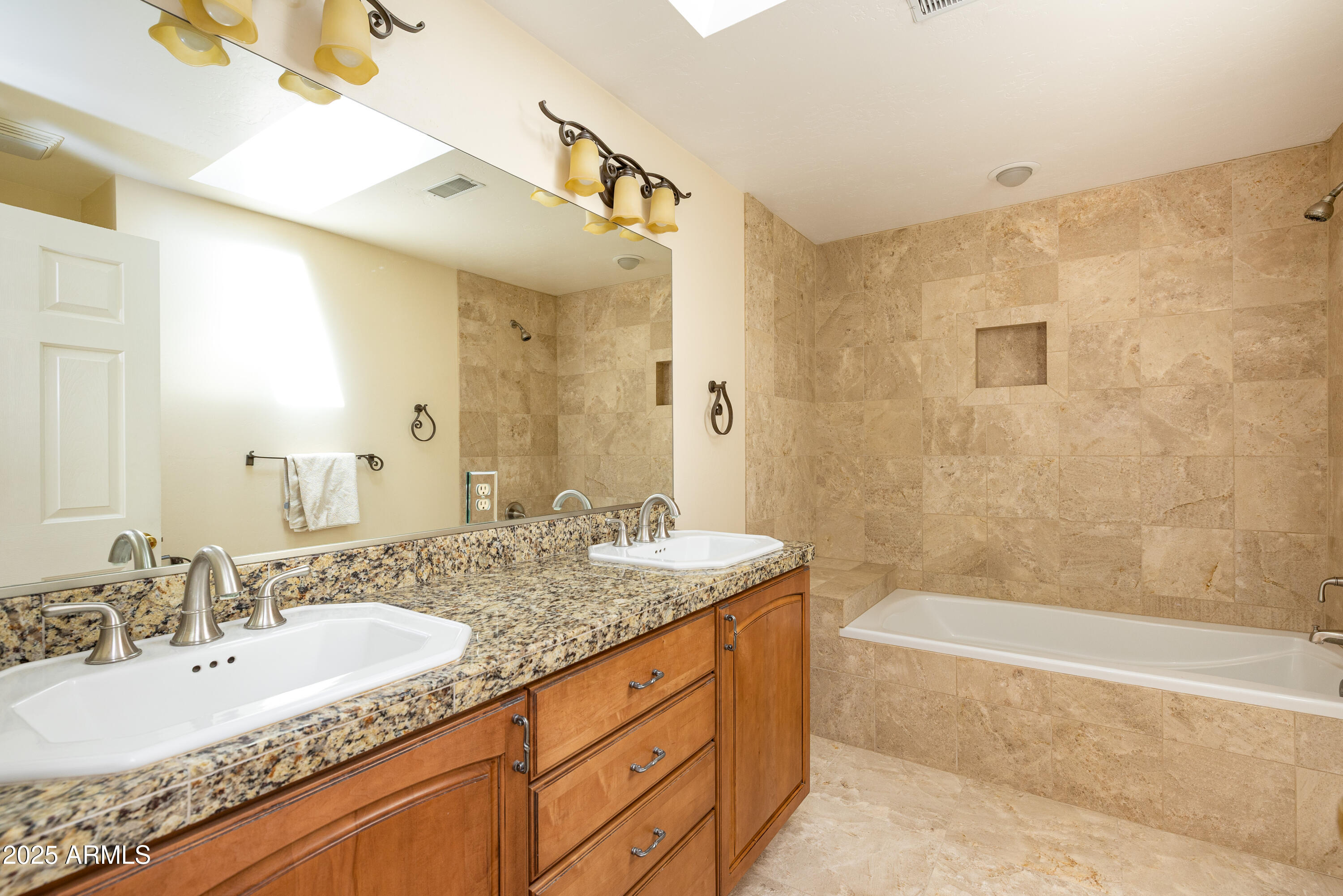 8230 Koch Field Road Flagstaff, AZ 86004 - Photo 38 of 69 a bathroom with a granite countertop sink a mirror a bathtub and shower