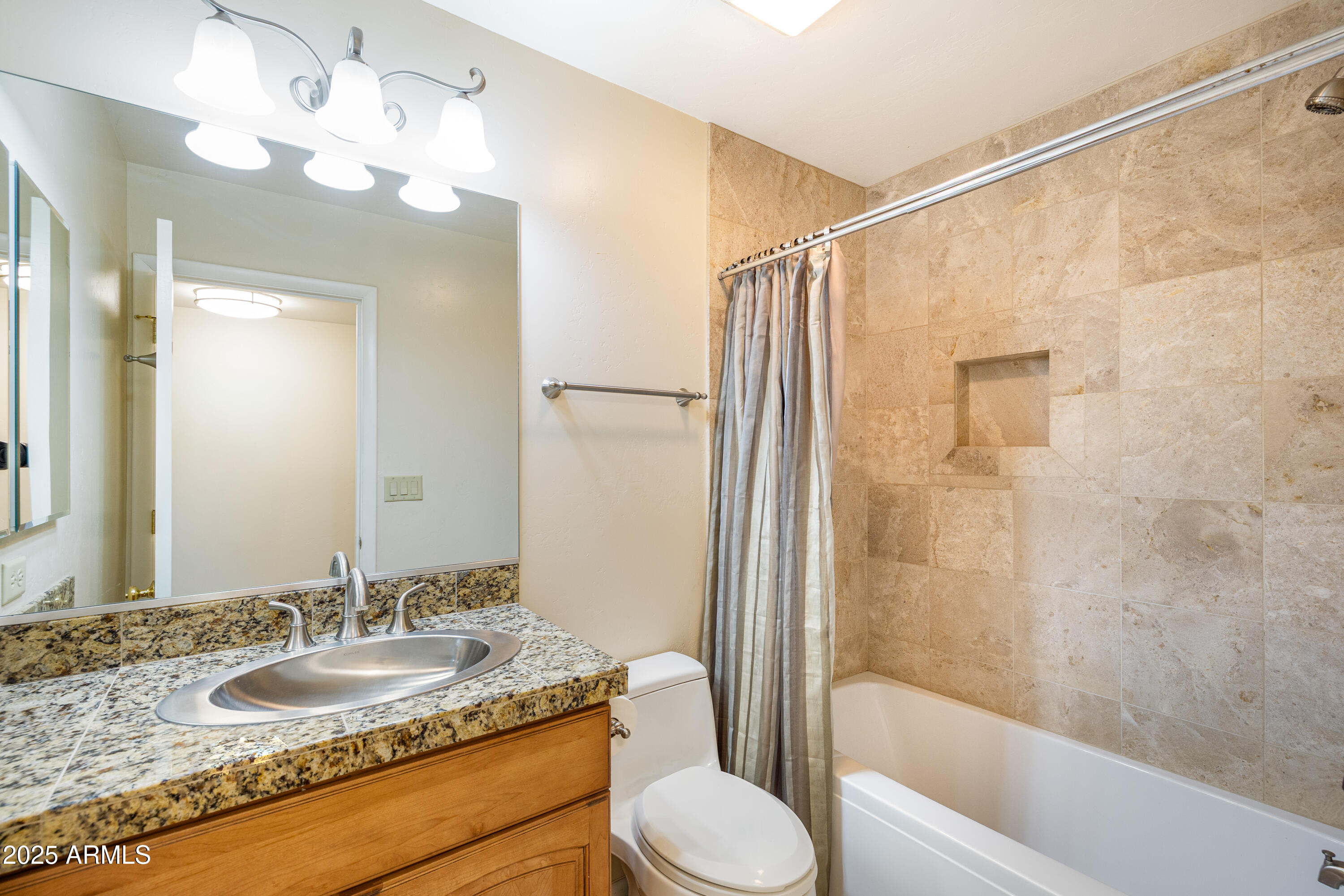 8230 Koch Field Road Flagstaff, AZ 86004 - Photo 40 of 69 a bathroom with a granite countertop sink toilet a mirror and shower