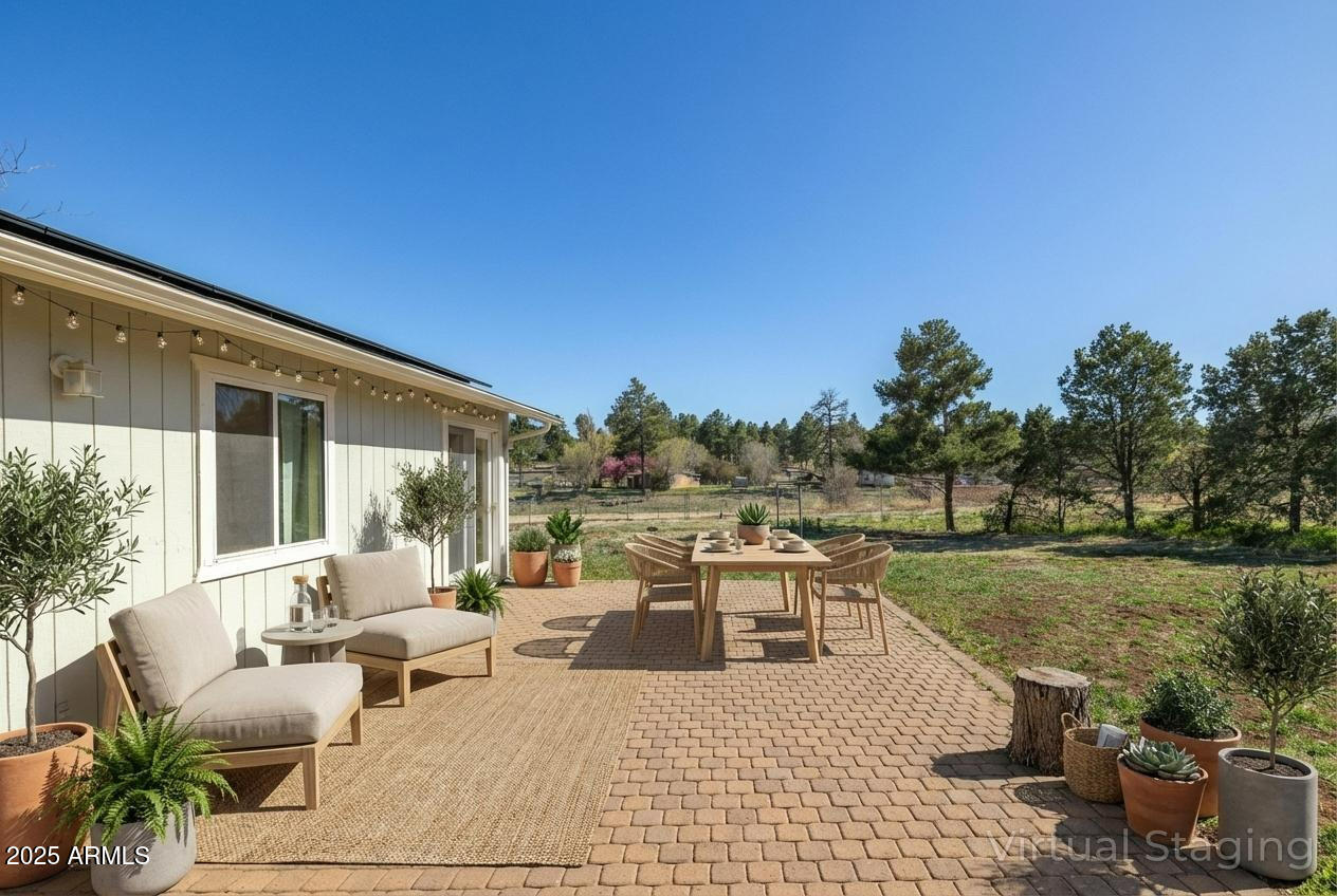 8230 Koch Field Road Flagstaff, AZ 86004 - Photo 50 of 69 a view of a patio with couches and table and chairs and potted plants