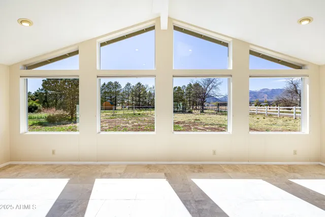 a large kitchen with stainless steel appliances granite countertop a stove a sink and a microwave