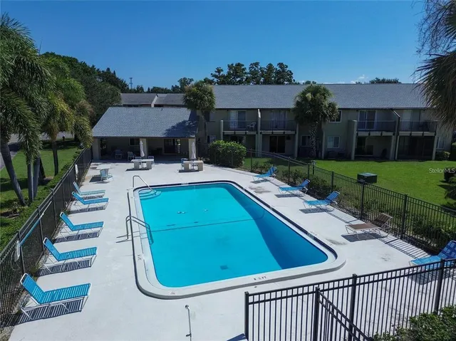 an aerial view of a house with a garden and a car parked