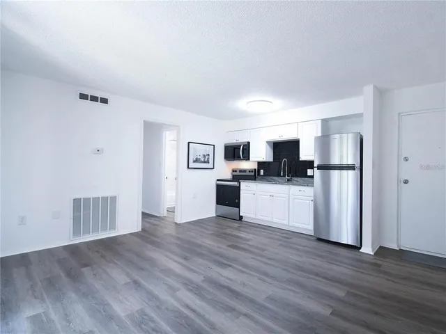 a kitchen with stainless steel appliances refrigerator sink and cabinets