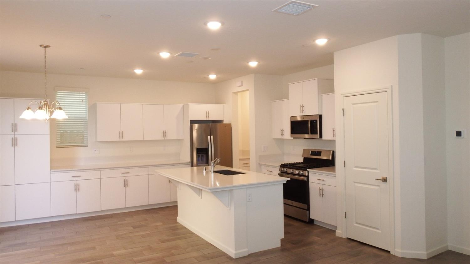 2008 North Walling Lane Clovis, CA 93619 - Photo 2 of 12 a kitchen with white cabinets and stainless steel appliances