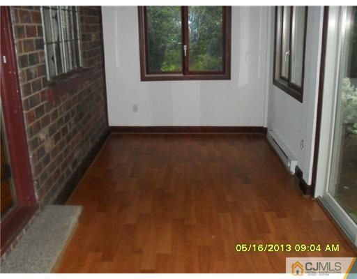 130 West Hill Road Colonia, NJ 07067 - Photo 3 of 7 a view of a room with wooden floor and windows