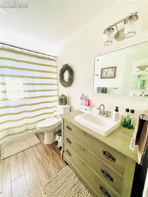 8715 Chipita Park Road Cascade, CO 80809 - Photo 13 of 25 a bathroom with a sink mirror and a toilet