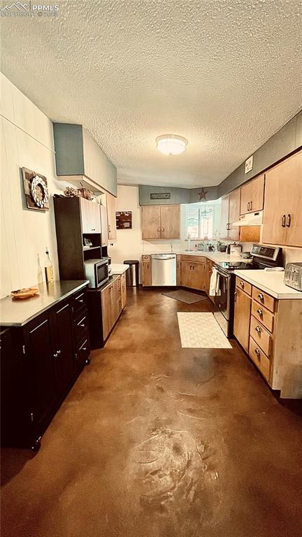 8715 Chipita Park Road Cascade, CO 80809 - Photo 16 of 25 a large kitchen with lots of counter space and stainless steel appliances