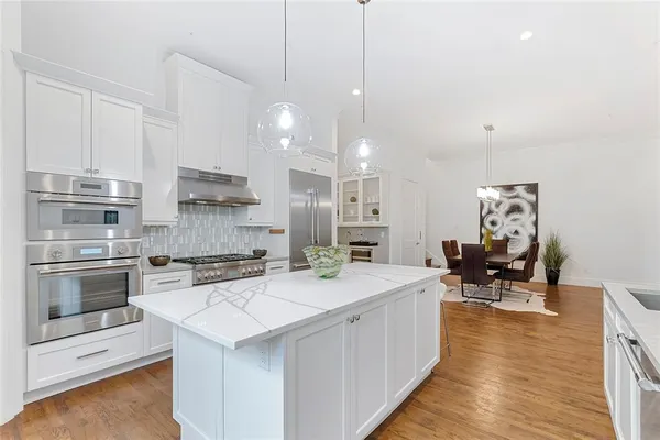 a kitchen with a sink cabinets and wooden floor
