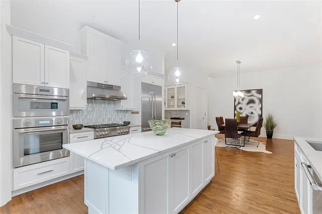 a kitchen with a sink cabinets and wooden floor