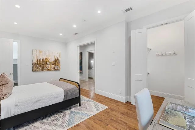 a bedroom with a bed and wooden floor