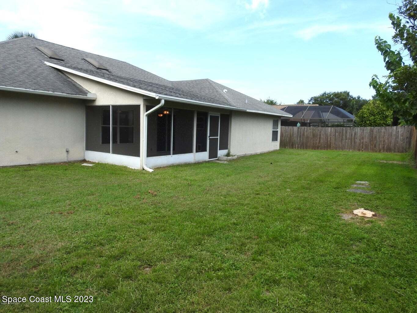 3368 Lakeview Circle Melbourne, FL 32934 - Photo 16 of 16 a view of a house with a yard