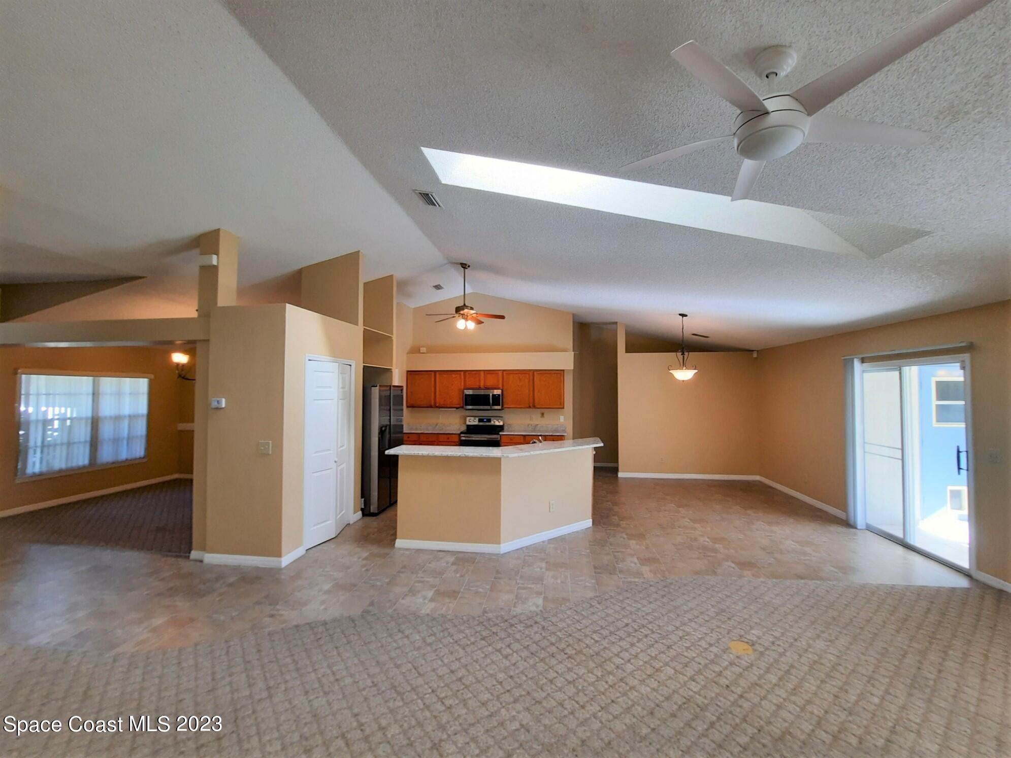 3368 Lakeview Circle Melbourne, FL 32934 - Photo 4 of 16 an empty room with a kitchen and a sink