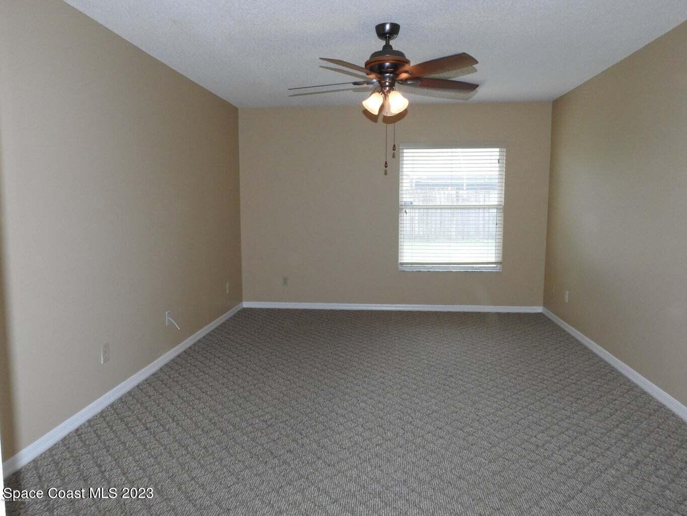 3368 Lakeview Circle Melbourne, FL 32934 - Photo 8 of 16 an empty room with a window