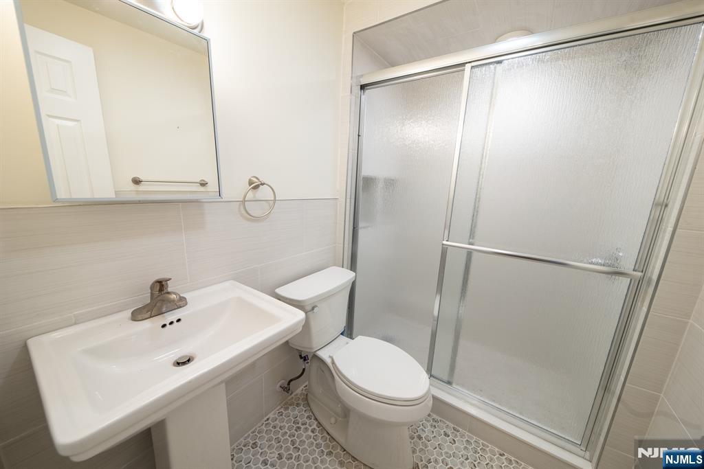 7723 Bergenline Avenue, Unit 3 North Bergen, NJ 07047 - Photo 9 of 12 a bathroom with a sink toilet and shower