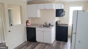 a kitchen with stainless steel appliances a refrigerator sink and cabinets