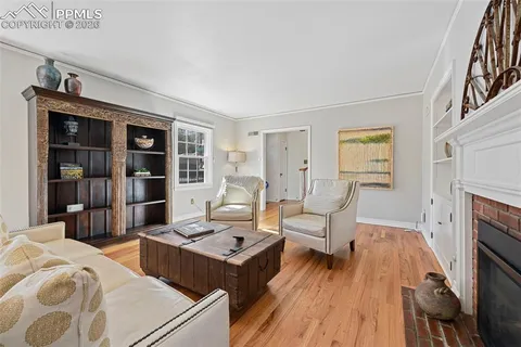a living room with furniture a fireplace and a table