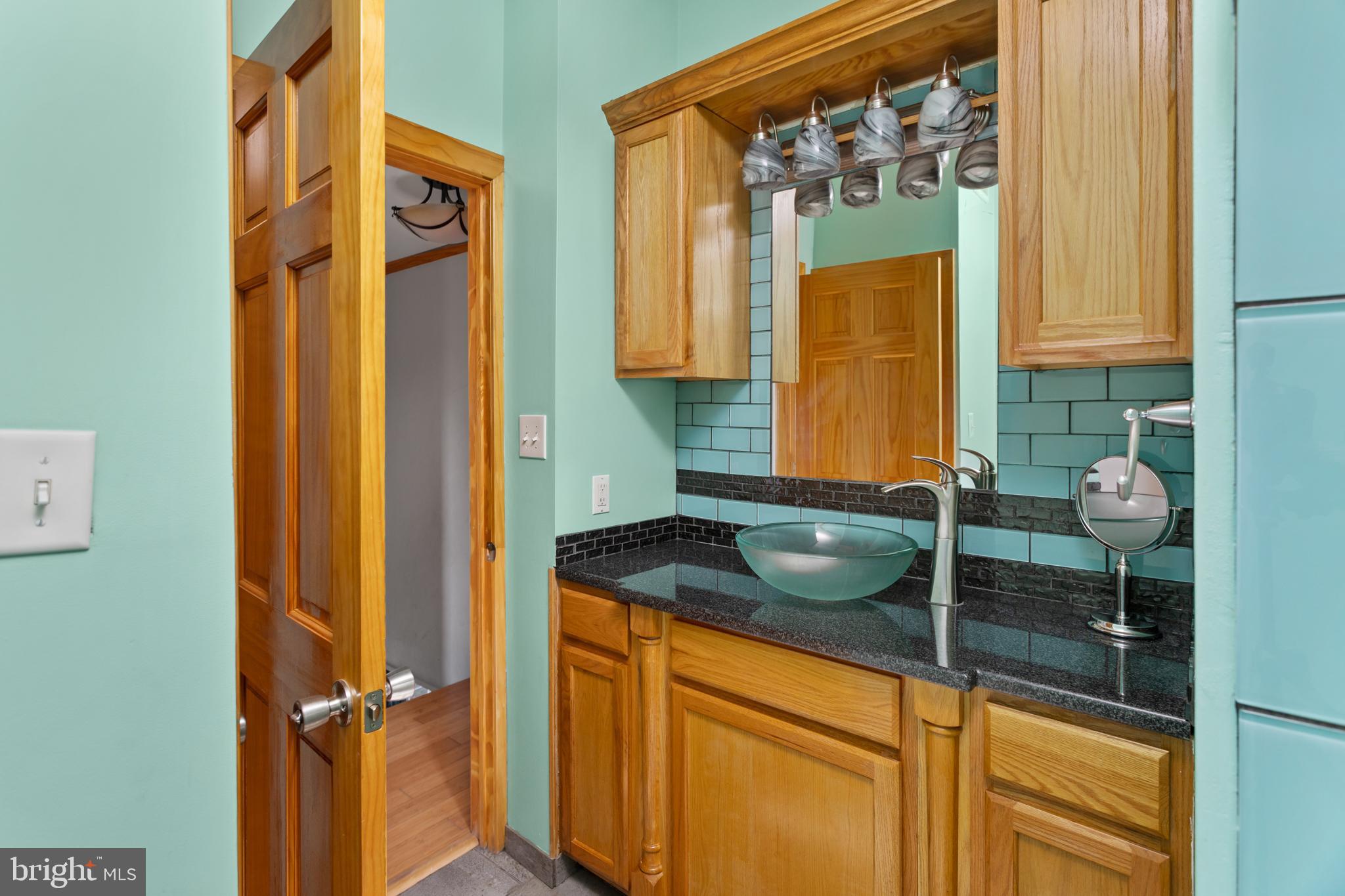 23 Cotton Road Levittown, PA 19057 - Photo 13 of 36 a bathroom with a granite countertop sink and a mirror