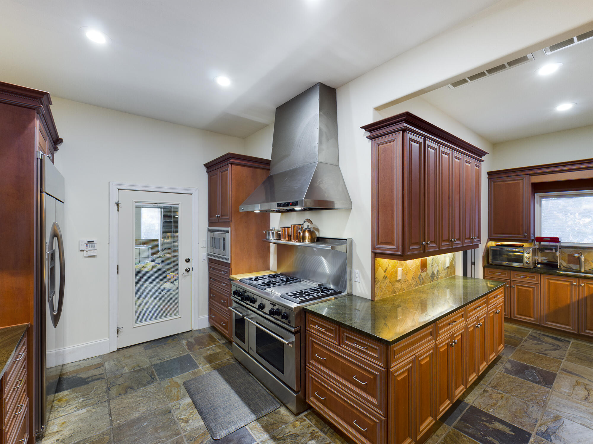 263 Leaning Pines Loop Destin, FL 32541 - Photo 21 of 58 a kitchen with stainless steel appliances granite countertop a stove a sink and a refrigerator