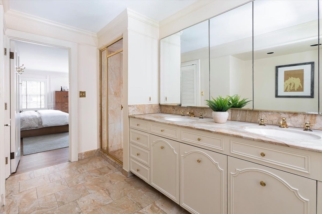 300 Warren Street Brookline, MA 02445 - Photo 19 of 35 a en suite bathroom with a granite countertop sink and a mirror