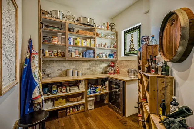 a kitchen with lots of clutter and cabinets