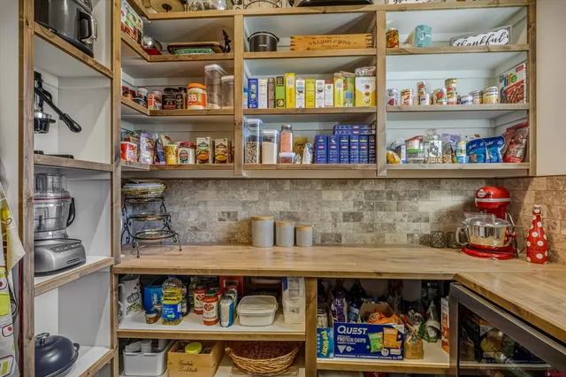 a kitchen with stainless steel appliances granite countertop table chairs and wooden cabinets