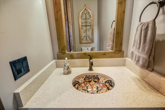 a bedroom with a bed and a flat tv screen on dresser