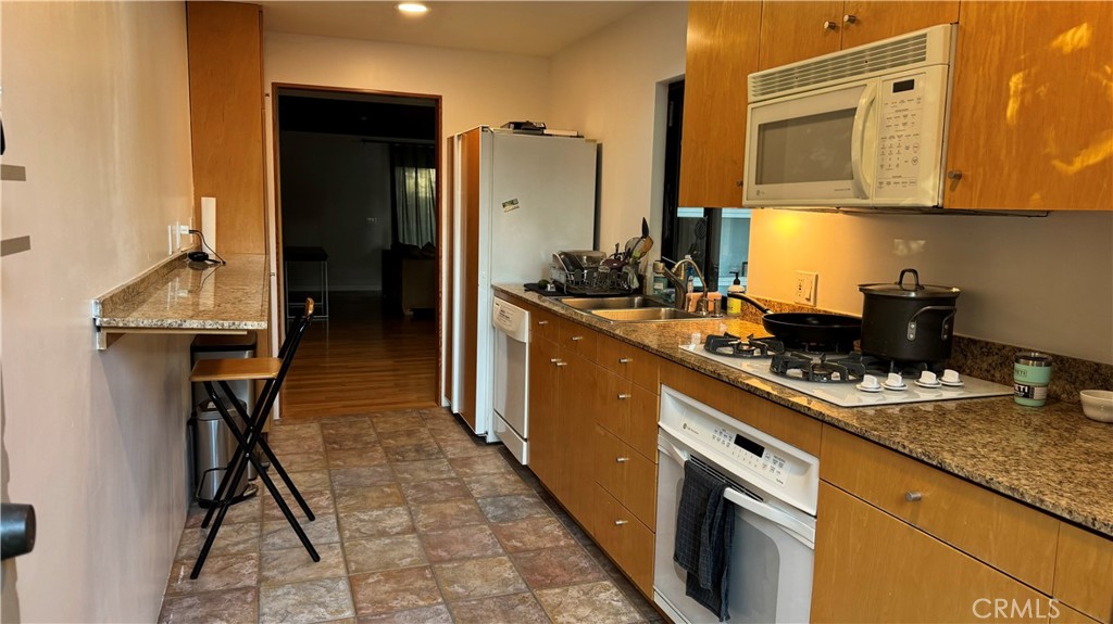 2117 Colby Avenue West Los Angeles, CA 90025 - Photo 10 of 43 a kitchen with stainless steel appliances granite countertop a sink stove and refrigerator