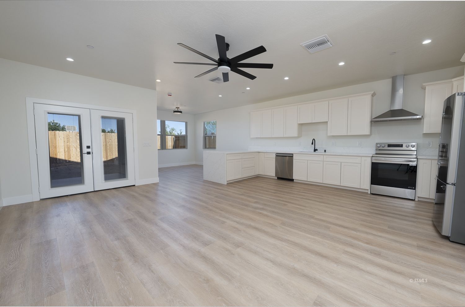 1528 Mayo Street Ridgecrest, CA 93555 - Photo 8 of 34 a large kitchen with a lot of cabinets and wooden floor