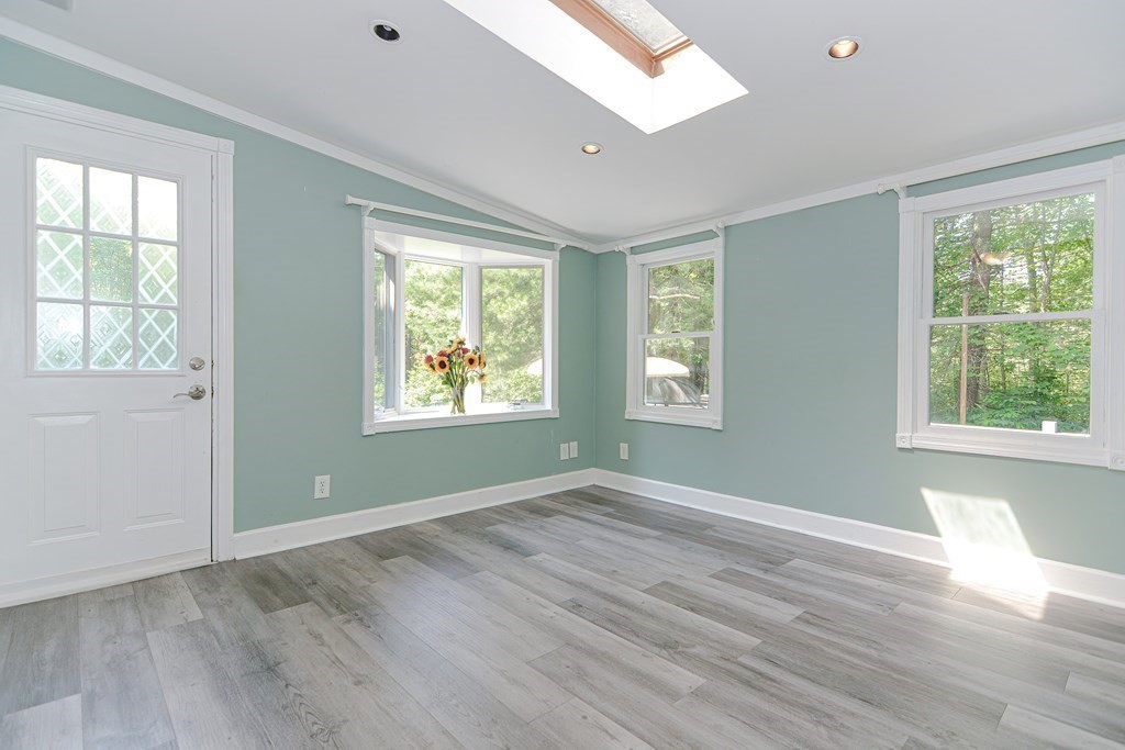 183 Brickel Road Stoughton, MA 02072 - Photo 12 of 38 a view of an empty room with wooden floor and a window