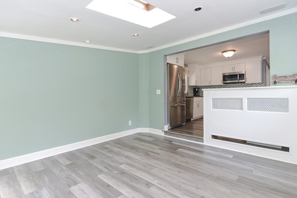 183 Brickel Road Stoughton, MA 02072 - Photo 14 of 38 a view of kitchen with stainless steel appliances cabinets and wooden floor