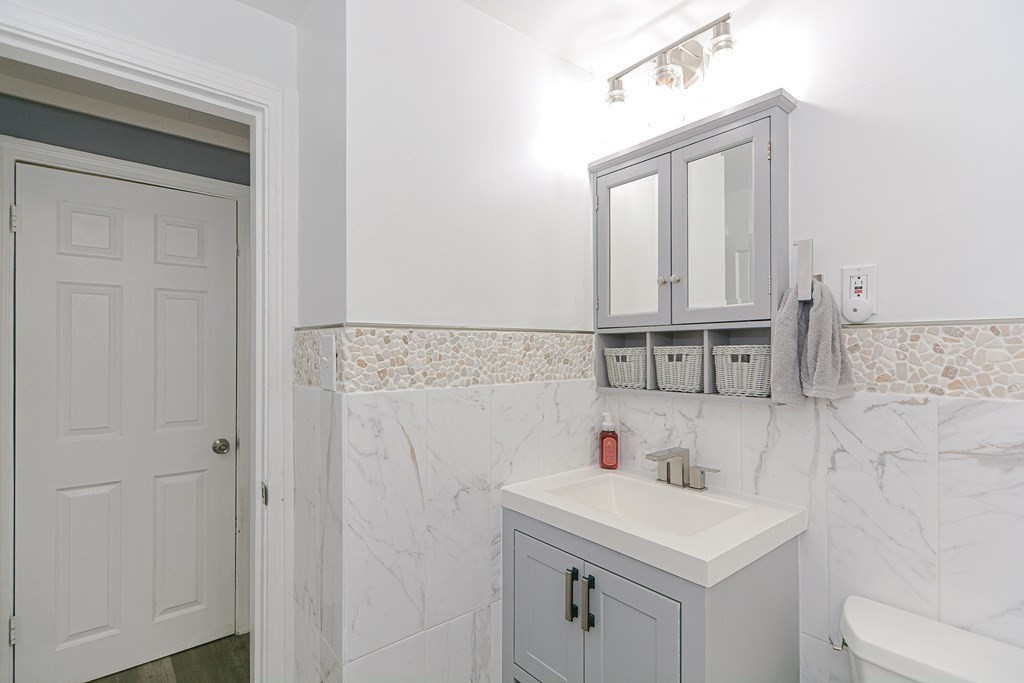 183 Brickel Road Stoughton, MA 02072 - Photo 17 of 38 a bathroom with a sink a toilet and mirror