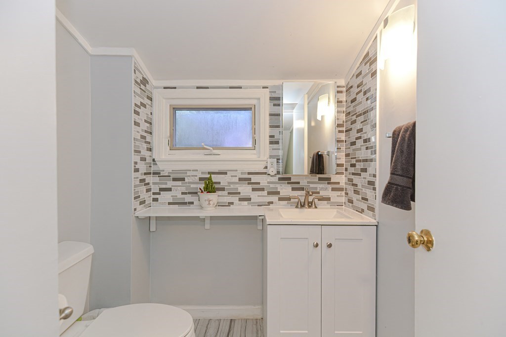 183 Brickel Road Stoughton, MA 02072 - Photo 18 of 38 a bathroom with a sink a toilet and mirror