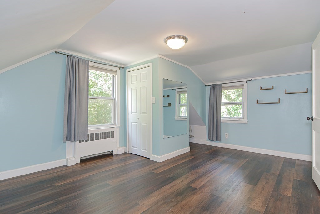 183 Brickel Road Stoughton, MA 02072 - Photo 19 of 38 an empty room with wooden floor and windows