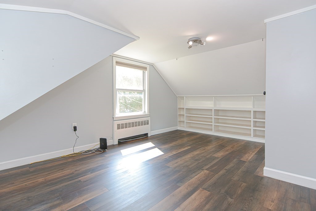 183 Brickel Road Stoughton, MA 02072 - Photo 22 of 38 an empty room with wooden floor and windows