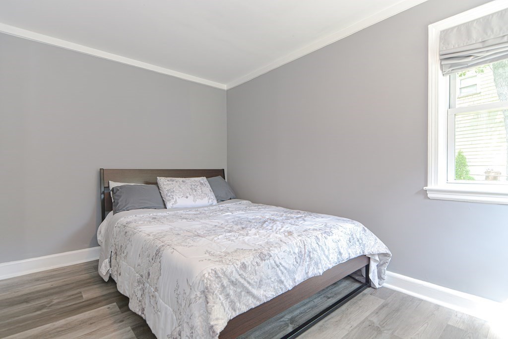 183 Brickel Road Stoughton, MA 02072 - Photo 25 of 38 a large bed sitting in a bedroom next to a window