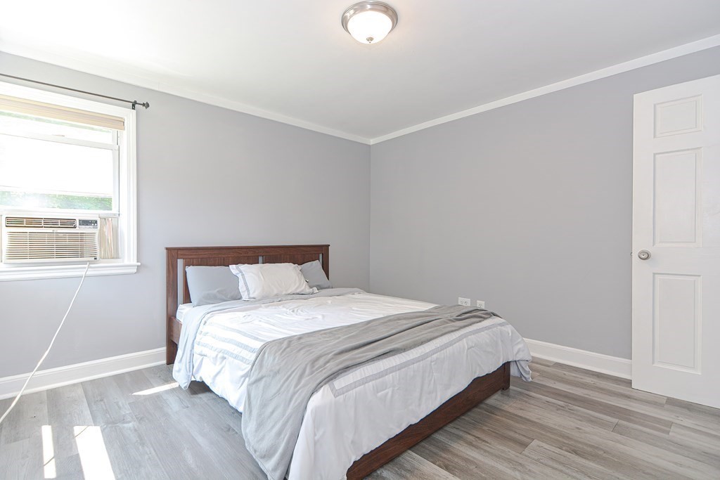 183 Brickel Road Stoughton, MA 02072 - Photo 26 of 38 a bedroom with a bed and wooden floor