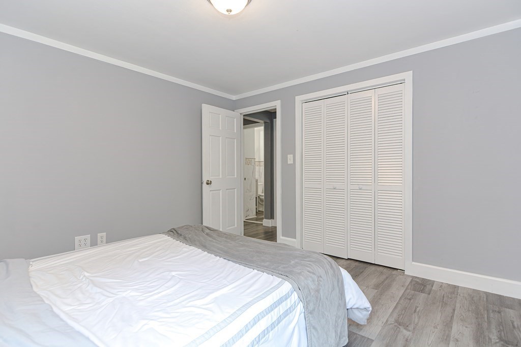 183 Brickel Road Stoughton, MA 02072 - Photo 27 of 38 a bedroom with a bed and a mirror