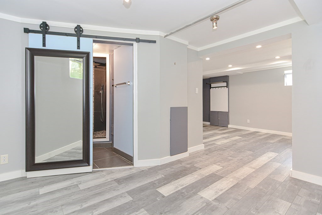 183 Brickel Road Stoughton, MA 02072 - Photo 30 of 38 a view of a hallway with wooden floor and closet
