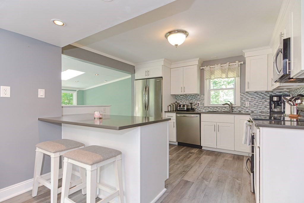 183 Brickel Road Stoughton, MA 02072 - Photo 3 of 38 a kitchen with stainless steel appliances kitchen island granite countertop a sink and cabinets