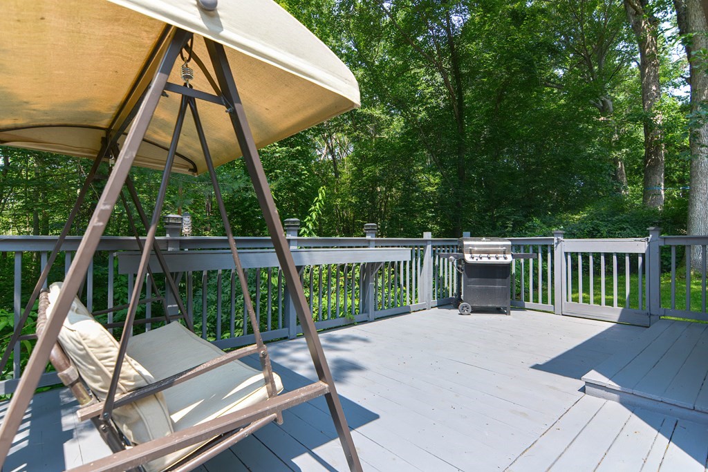 183 Brickel Road Stoughton, MA 02072 - Photo 36 of 38 a view of a deck with two chair and large trees