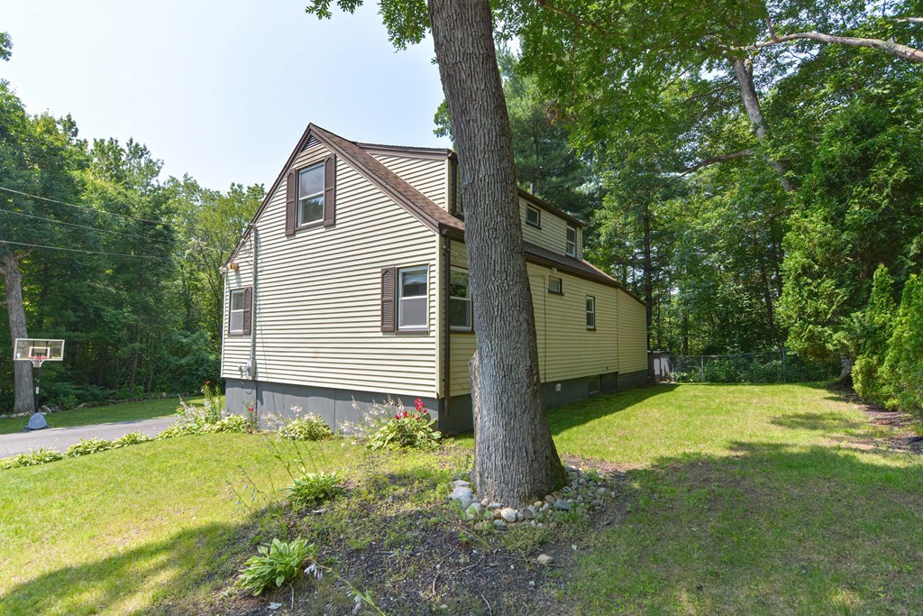 183 Brickel Road Stoughton, MA 02072 - Photo 37 of 38 a backyard of a house with plants and large tree