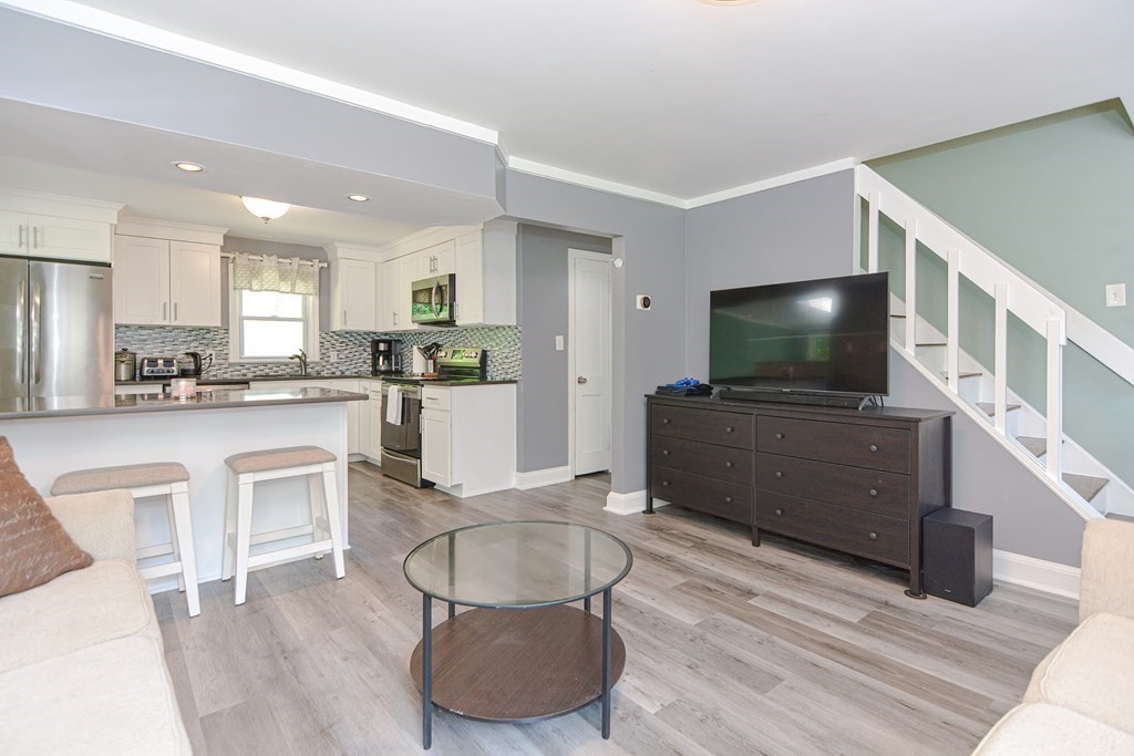 183 Brickel Road Stoughton, MA 02072 - Photo 7 of 38 a kitchen with white cabinets and stainless steel appliances
