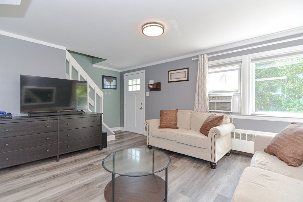 183 Brickel Road Stoughton, MA 02072 - Photo 8 of 38 a living room with furniture and a flat screen tv