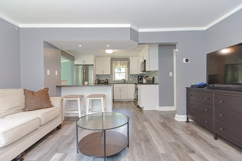 183 Brickel Road Stoughton, MA 02072 - Photo 9 of 38 a living room with furniture and kitchen view
