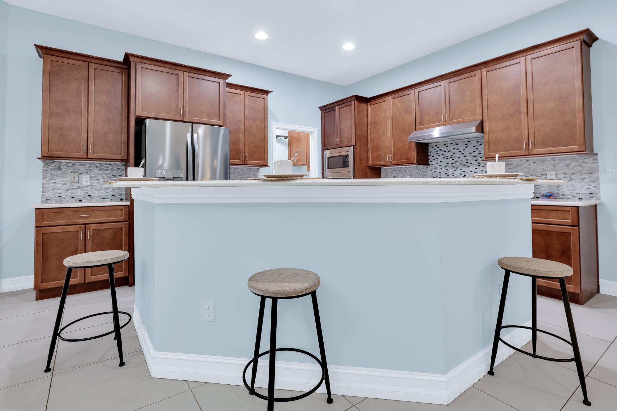 113 Needle Palm Drive St. Augustine, FL 32086 - Photo 12 of 46 a kitchen with stainless steel appliances granite countertop a sink refrigerator and cabinets